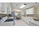 Bright kitchen featuring white cabinetry, modern appliances, and a view to an adjacent dining area at 8404 Imperial Cir # 8404, Palmetto, FL 34221