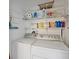 Efficient laundry room with modern washer and dryer, plus shelving and storage for cleaning supplies at 8404 Imperial Cir # 8404, Palmetto, FL 34221