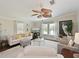 Bright living room featuring a ceiling fan, plush carpeting, and ample natural light at 8404 Imperial Cir # 8404, Palmetto, FL 34221