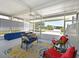 Inviting screened-in lanai featuring an outdoor ceiling fan, comfortable seating, and stylish decor at 8404 Imperial Cir # 8404, Palmetto, FL 34221