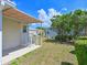 View of a lush backyard with a well-maintained lawn, mature trees, and a glimpse of neighboring homes at 8404 Imperial Cir # 8404, Palmetto, FL 34221