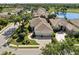 Beautiful aerial view of a home with a tile roof, a two-car garage, lush landscaping, and close proximity to a golf course at 8630 51St E Ter, Bradenton, FL 34211