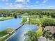 Panoramic aerial view showcasing the golf course, water features, bridge, and clubhouse at 8630 51St E Ter, Bradenton, FL 34211