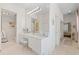 Stylish bathroom featuring a vanity with seating, a large mirror, and ample storage at 8630 51St E Ter, Bradenton, FL 34211