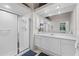 Bathroom featuring a glass enclosed shower and white vanity with large mirror at 8630 51St E Ter, Bradenton, FL 34211