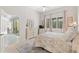 Light-filled bedroom with dresser, complemented by a patterned bedspread and plush carpet at 8630 51St E Ter, Bradenton, FL 34211