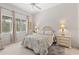 Comfortable bedroom featuring neutral tones, a ceiling fan, and natural light from the window at 8630 51St E Ter, Bradenton, FL 34211