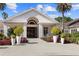 Beautiful clubhouse exterior with well-manicured landscaping and inviting entrance at 8630 51St E Ter, Bradenton, FL 34211