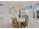 Cozy dining room with elegant chandelier and a view to the outdoor grill at 8630 51St E Ter, Bradenton, FL 34211