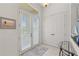Inviting foyer with double doors, tile floor, and glass table at 8630 51St E Ter, Bradenton, FL 34211