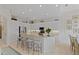 Modern kitchen with stainless steel appliances, a center island, and adjacent dining area at 8630 51St E Ter, Bradenton, FL 34211