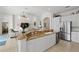 Bright kitchen with granite countertops, white cabinets, and an island open to the living area at 8630 51St E Ter, Bradenton, FL 34211