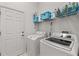 Functional laundry room with washer, dryer, and overhead storage shelf at 8630 51St E Ter, Bradenton, FL 34211