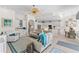 Open-concept living room featuring a ceiling fan and views into the kitchen at 8630 51St E Ter, Bradenton, FL 34211