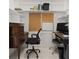 Home office with a built in desk, cork boards and tile floor at 8630 51St E Ter, Bradenton, FL 34211