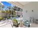 Screened patio with outdoor dining set and view of the landscaped yard at 8630 51St E Ter, Bradenton, FL 34211