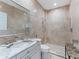 Elegant bathroom featuring marble countertops, a large mirror, and a glass-enclosed shower at 8687 Woodbriar Dr, Sarasota, FL 34238