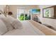 Bedroom featuring a large window with views of tropical landscaping at 8687 Woodbriar Dr, Sarasota, FL 34238