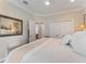 Cozy bedroom with a view into another bedroom and an oversized mirror at 8687 Woodbriar Dr, Sarasota, FL 34238