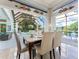 Elegant dining room with view of covered lanai, pool and backyard at 8687 Woodbriar Dr, Sarasota, FL 34238