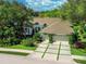 Beautifully landscaped home with a three-car garage and lovely trees at 8687 Woodbriar Dr, Sarasota, FL 34238