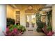Inviting front entrance with double doors, decorative light fixture, and lush landscaping at 8687 Woodbriar Dr, Sarasota, FL 34238
