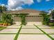 A charming single-Gathering home with a large garage, nice landscaping, and a well-maintained concrete driveway at 8687 Woodbriar Dr, Sarasota, FL 34238