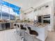 Modern kitchen features an expansive island, bar seating, and high-end stainless steel appliances at 8687 Woodbriar Dr, Sarasota, FL 34238