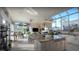 Bright kitchen with stainless steel appliances, granite countertops, and an island with a cooktop at 8687 Woodbriar Dr, Sarasota, FL 34238