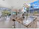 Open kitchen featuring a large island, modern pendant lighting, and outside views at 8687 Woodbriar Dr, Sarasota, FL 34238
