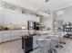 Modern kitchen with a large marble island, stylish seating, and stainless steel appliances at 8687 Woodbriar Dr, Sarasota, FL 34238