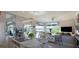 Bright kitchen with stainless steel appliances, granite countertops, and an island with a cooktop at 8687 Woodbriar Dr, Sarasota, FL 34238