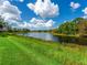 This lush backyard has a beautiful lake view, perfect for enjoying nature at 8687 Woodbriar Dr, Sarasota, FL 34238