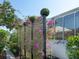 A modern privacy screen with climbing bougainvillea adorns the side of this beautiful home at 8687 Woodbriar Dr, Sarasota, FL 34238