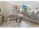 Open-concept living room with ample seating, modern decor, and seamless access to kitchen at 8687 Woodbriar Dr, Sarasota, FL 34238