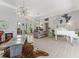Open floor plan features modern decor, statement lighting, and seamless flow from the office at 8687 Woodbriar Dr, Sarasota, FL 34238