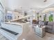 Elegant living room with white piano, stylish sofa, and mirrored accent table at 8687 Woodbriar Dr, Sarasota, FL 34238