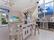 Sitting area with television, wet bar, and wall decorations with a view to the pool beyond at 8687 Woodbriar Dr, Sarasota, FL 34238