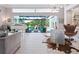 Elegant living room showcasing stylish decor, comfortable seating, and seamless access to the outdoor pool area at 8687 Woodbriar Dr, Sarasota, FL 34238