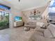 Inviting living room with plush seating, modern media center and bright views of the lanai at 8687 Woodbriar Dr, Sarasota, FL 34238