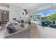 Bright living room featuring hardwood floors, comfortable sofa, and large windows to the pool area at 8687 Woodbriar Dr, Sarasota, FL 34238