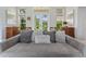 Comfortable living room featuring a plush sofa adorned with decorative pillows and view of outdoor patio at 8687 Woodbriar Dr, Sarasota, FL 34238