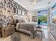 Modern main bedroom features luxurious bedding, stylish wall decor, and a serene ambiance at 8687 Woodbriar Dr, Sarasota, FL 34238