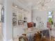 Home office boasts custom built-ins, modern lighting, and a unique metal desk with a leather chair at 8687 Woodbriar Dr, Sarasota, FL 34238