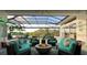 Inviting outdoor living space featuring comfortable seating, fire pit, and scenic pool and lake views at 8687 Woodbriar Dr, Sarasota, FL 34238