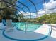 Relaxing screened pool overlooking beautiful backyard landscaping and serene water views at 8687 Woodbriar Dr, Sarasota, FL 34238