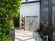 An exterior storage shed sits beside tropical landscaping, providing needed storage at 8687 Woodbriar Dr, Sarasota, FL 34238