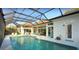 Enjoy swimming in this screened-in pool with serene lake views and lush landscaping at 8687 Woodbriar Dr, Sarasota, FL 34238