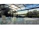 Enjoy swimming in this screened-in pool with an attached spa and expansive lake views at 8687 Woodbriar Dr, Sarasota, FL 34238