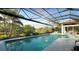 Enjoy swimming in this screened-in pool with serene lake views and lush landscaping at 8687 Woodbriar Dr, Sarasota, FL 34238